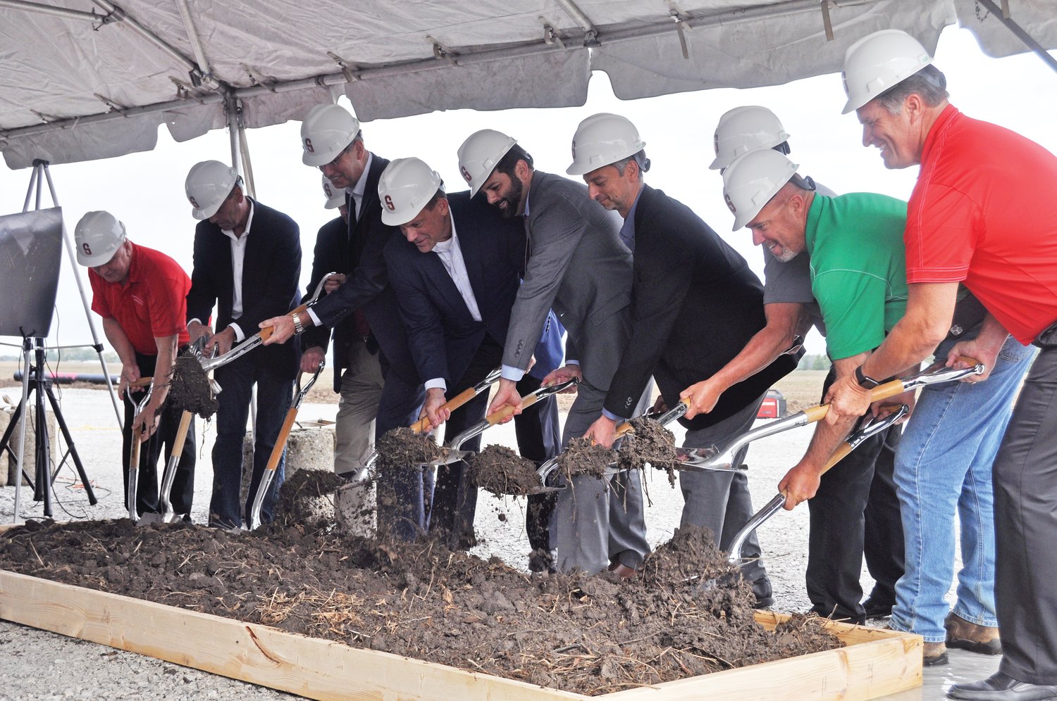 Dignitaries turn dirt at a groundbreaking ceremony for the Tempur Sealy plant on Thursday.